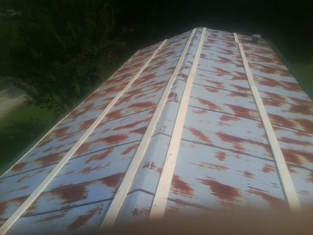 Rusted metal roof panels with new wood purlins before replacement — Storm Damage Roof Repair in Broomall by Roofing Brothers