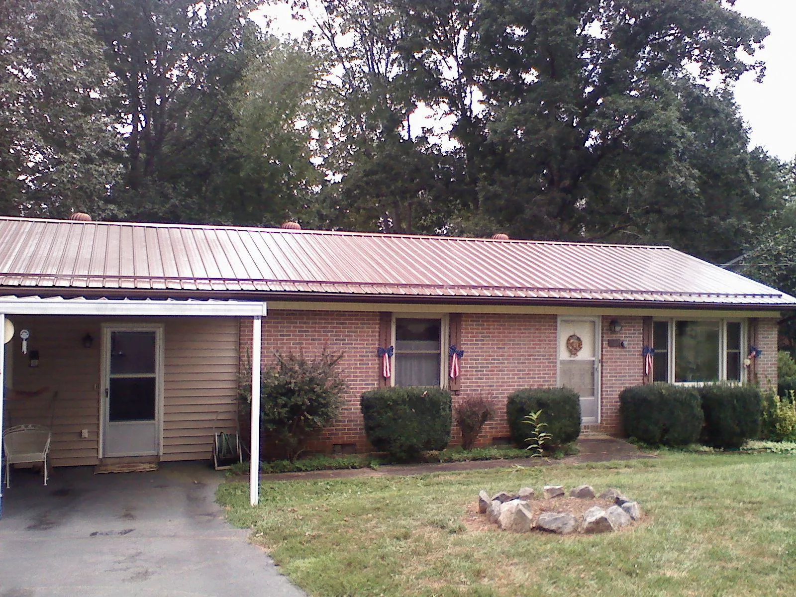 Bronze metal roof and carport on a brick ranch home — Roof Repair work by our crew in Broomall